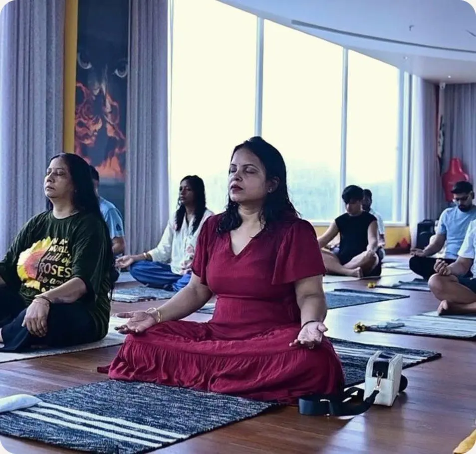 Yatri seated cross-legged with eyes closed during breathwork