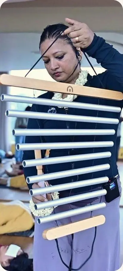 The facilitator playing a set of hanging chimes