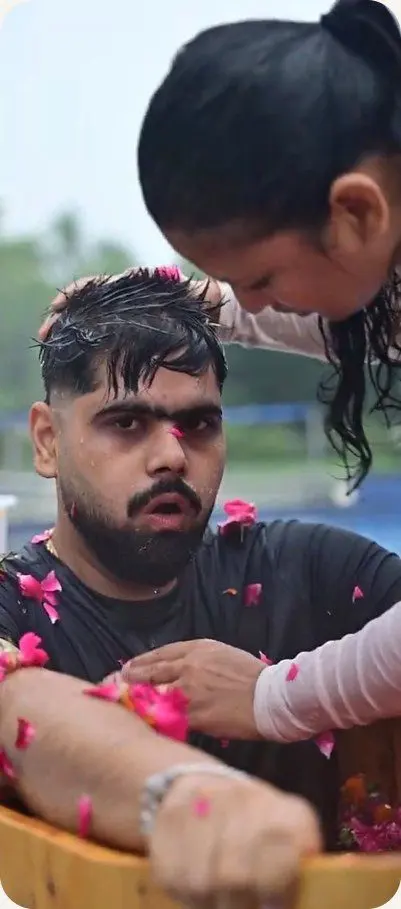 A Yatri with flower petals in his hair after the circle